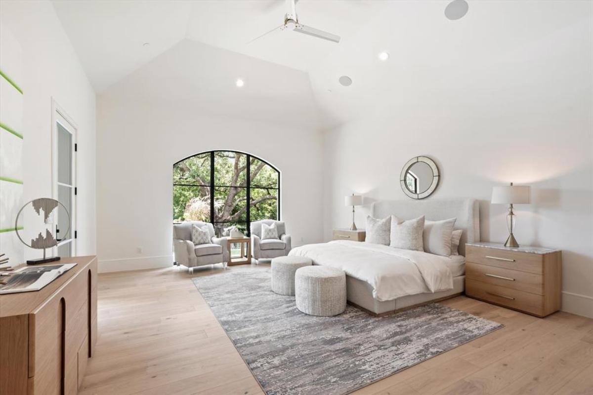Bedroom with a large bed and hardwood floors.
