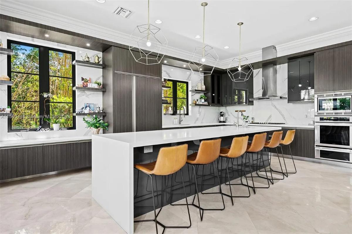 Kitchen with stainless-steel appliances and a counter breakfast bar.