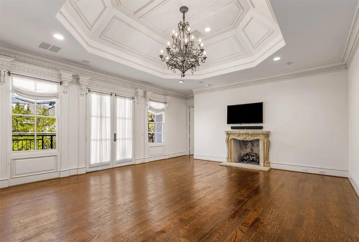 Bedroom with a chandelier and a fireplace.