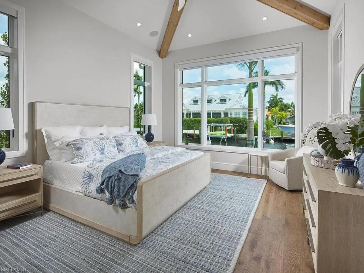 Bedroom with a large bed and hardwood floors.