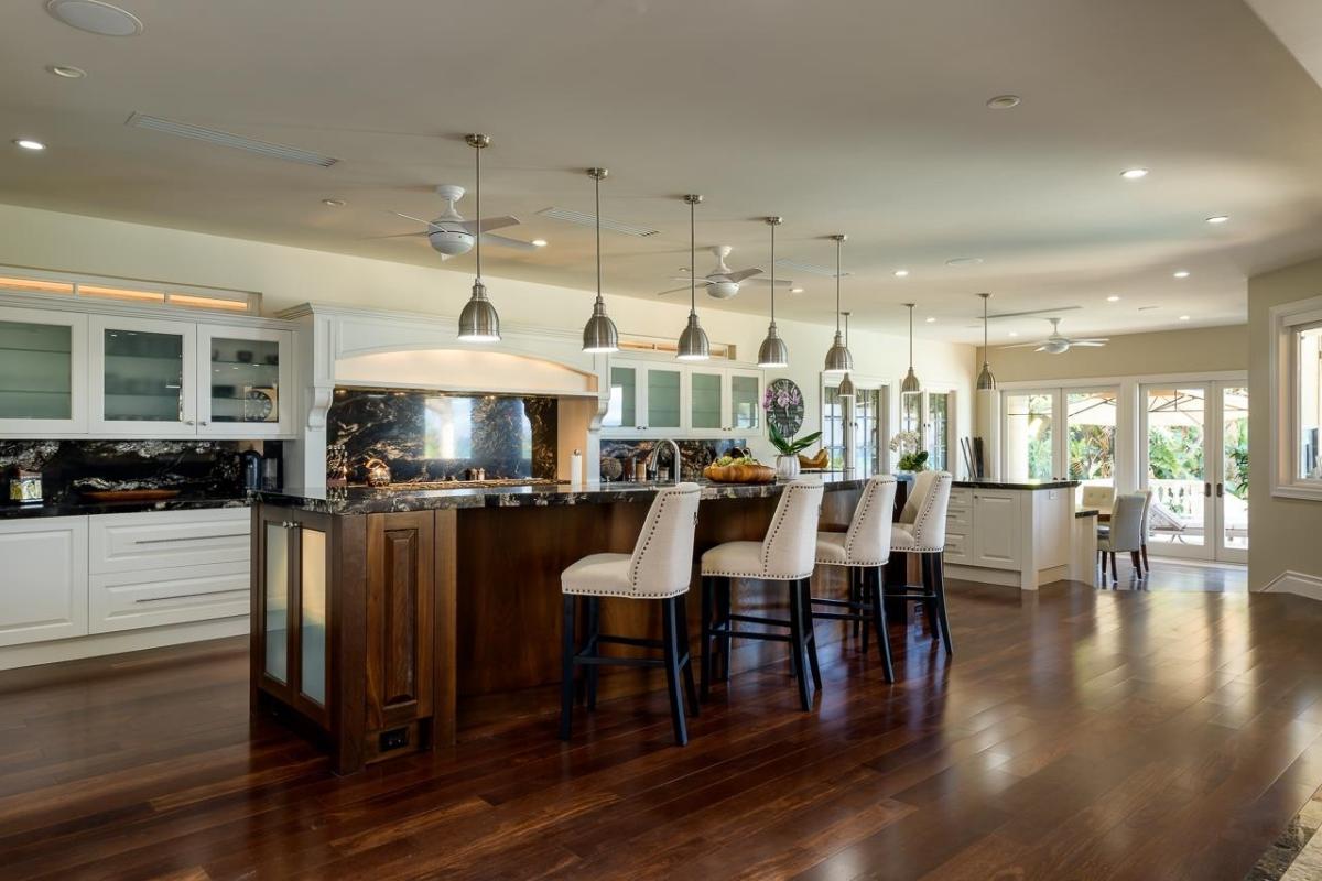 Kitchen with custom cabinetry and a spacious granite counter breakfast bar.