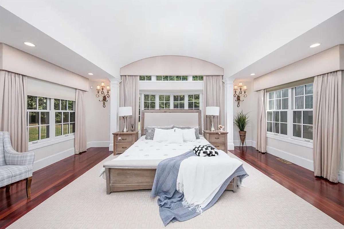 Bedroom with a large bed and hardwood floors.