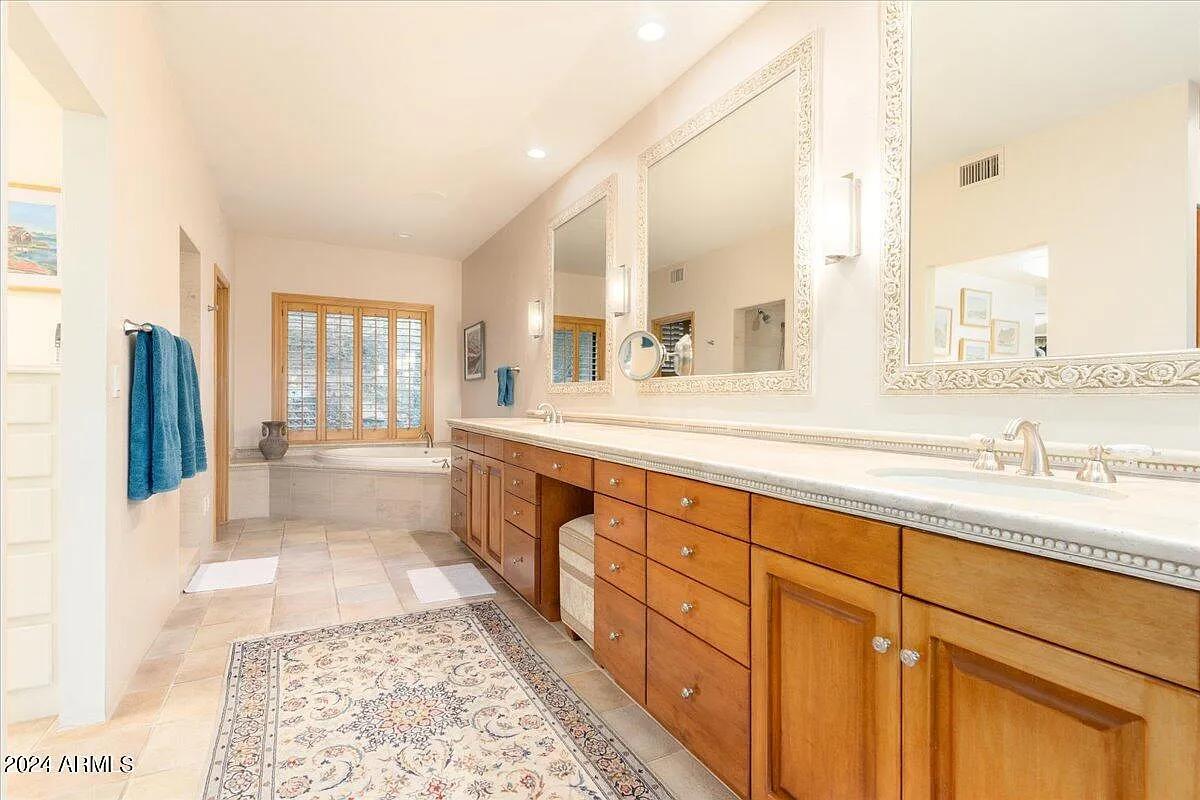 Bathroom with a custom-made vanity and a soaking tub.