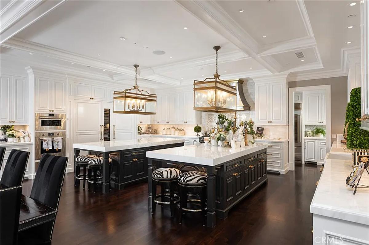 Kitchen with custom cabinetry and dual island prep area.