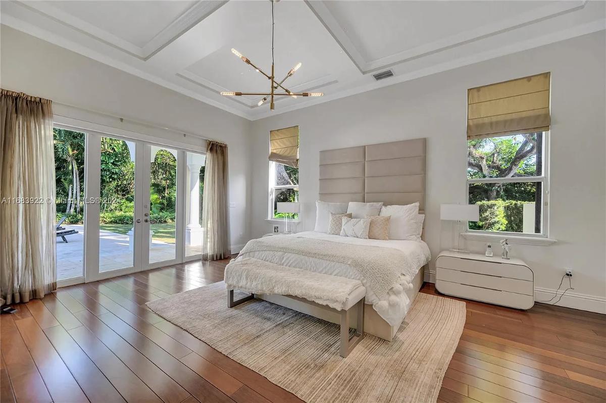 Bedroom with a large bed and hardwood floors.