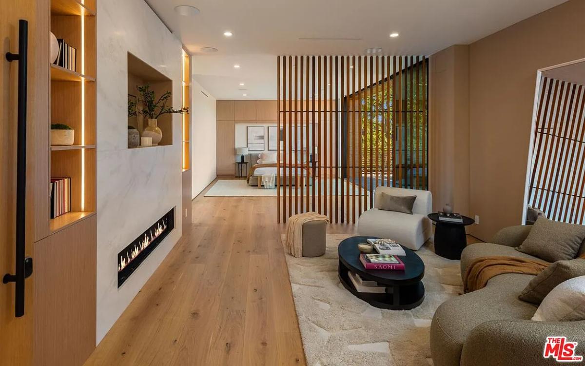 Living room with couches and a fireplace.