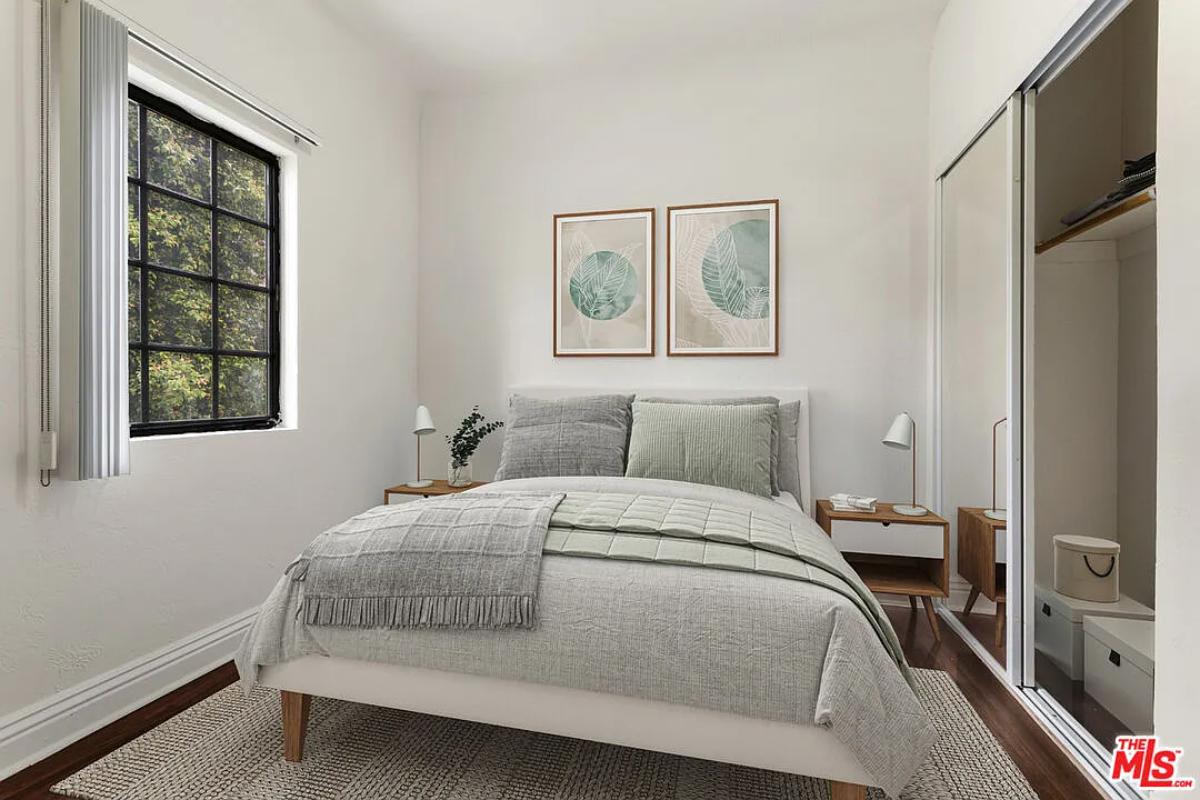 Bedroom with a large bed and hardwood floors.