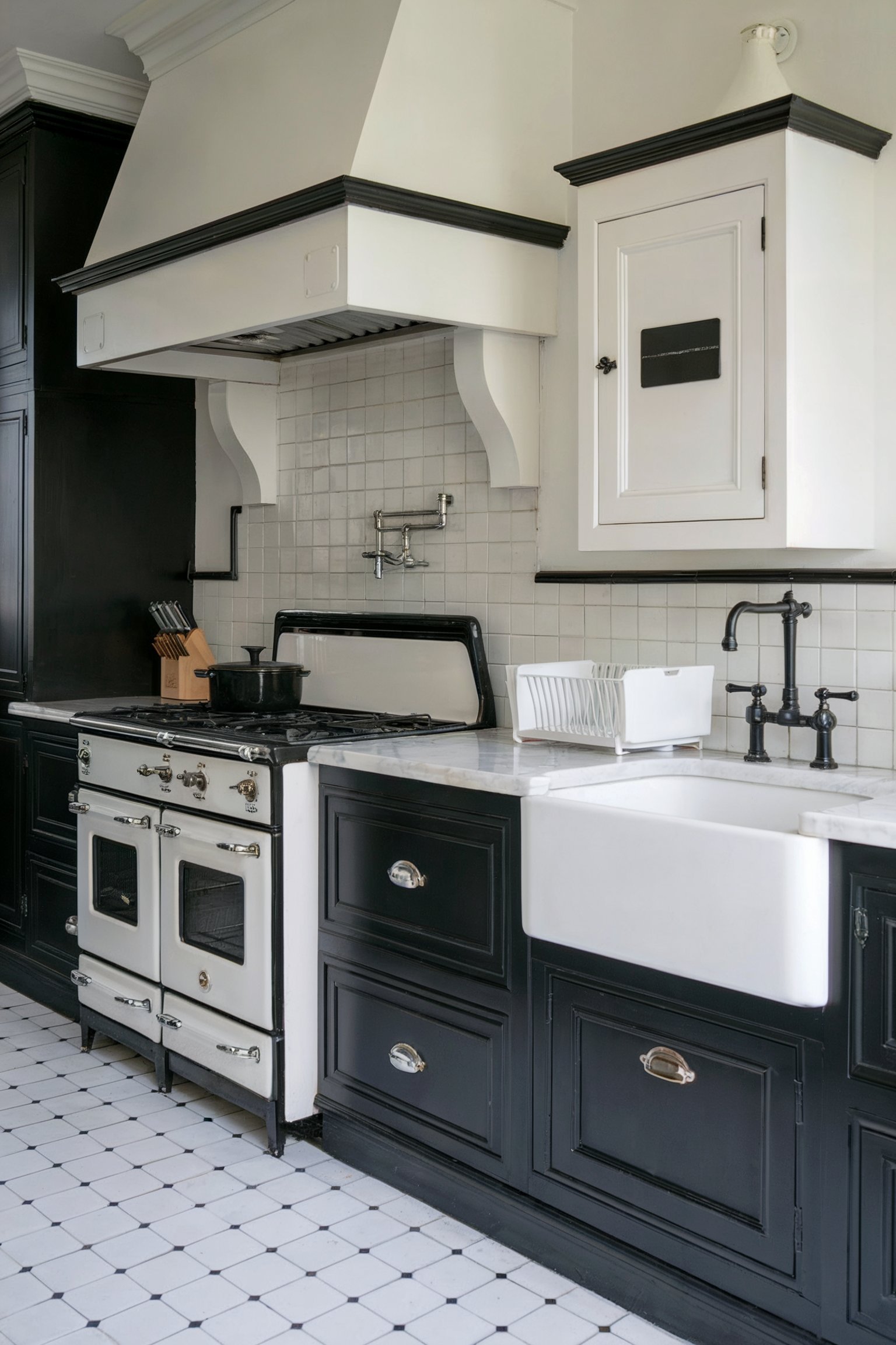 A classic-style kitchen with black lower cabinets, a white farmhouse sink, a vintage white stove with black accents, and a tiled backsplash