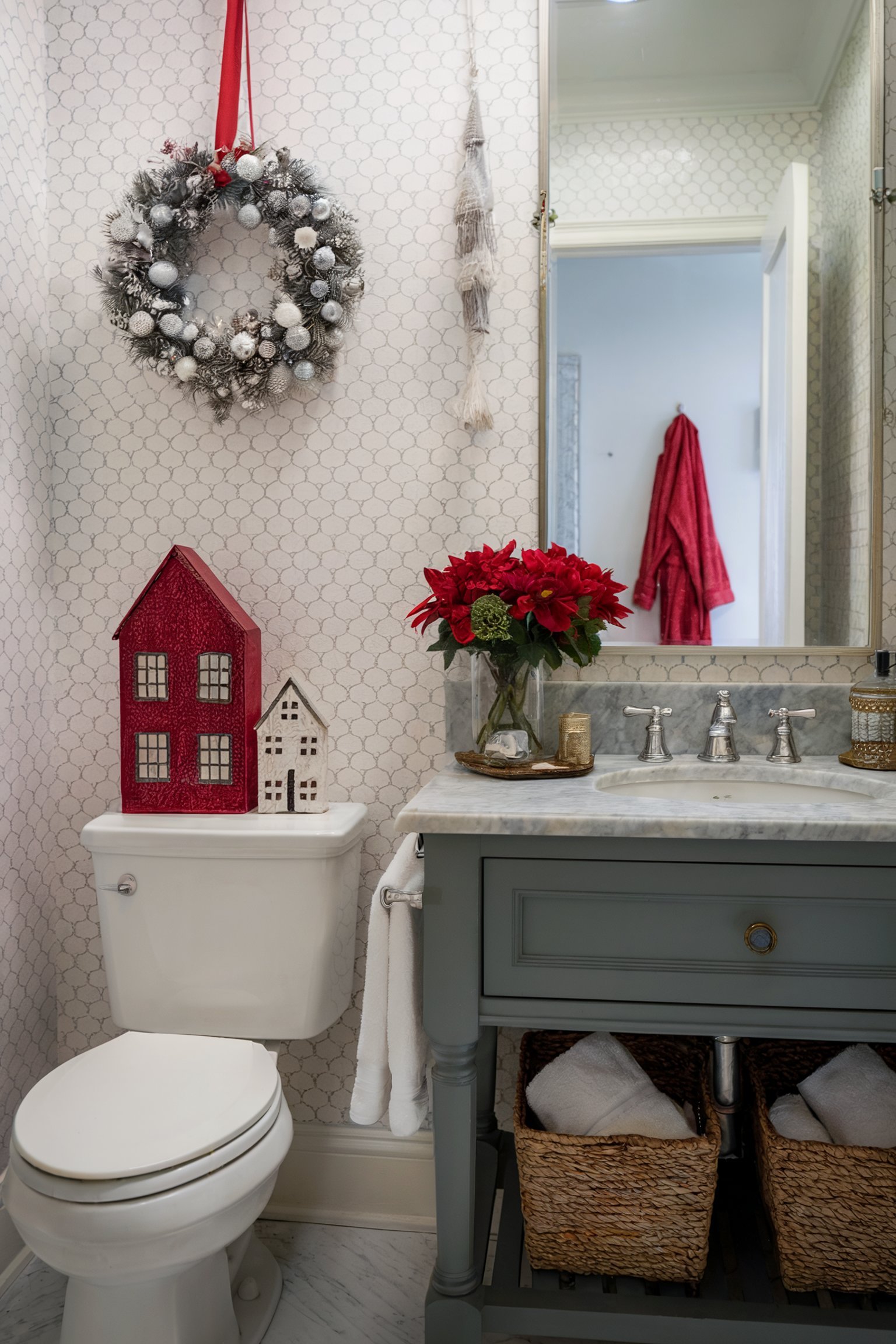 A bathroom with a wreath on the wall, red Christmas decorations, and a green vanity next to a toilet