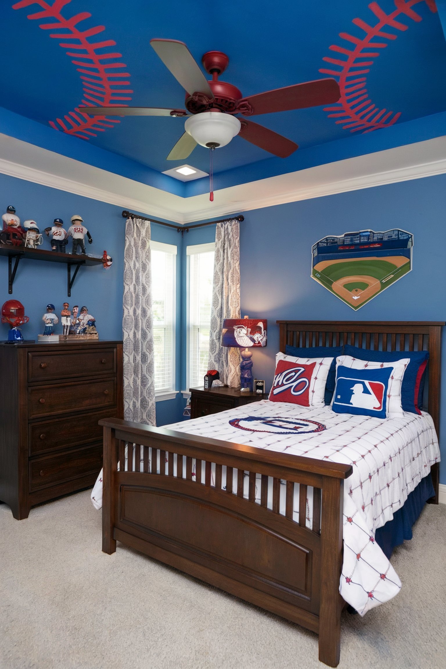 A baseball-themed bedroom with a blue ceiling featuring red stitching, wooden bed and dresser, and decor highlighting a baseball field