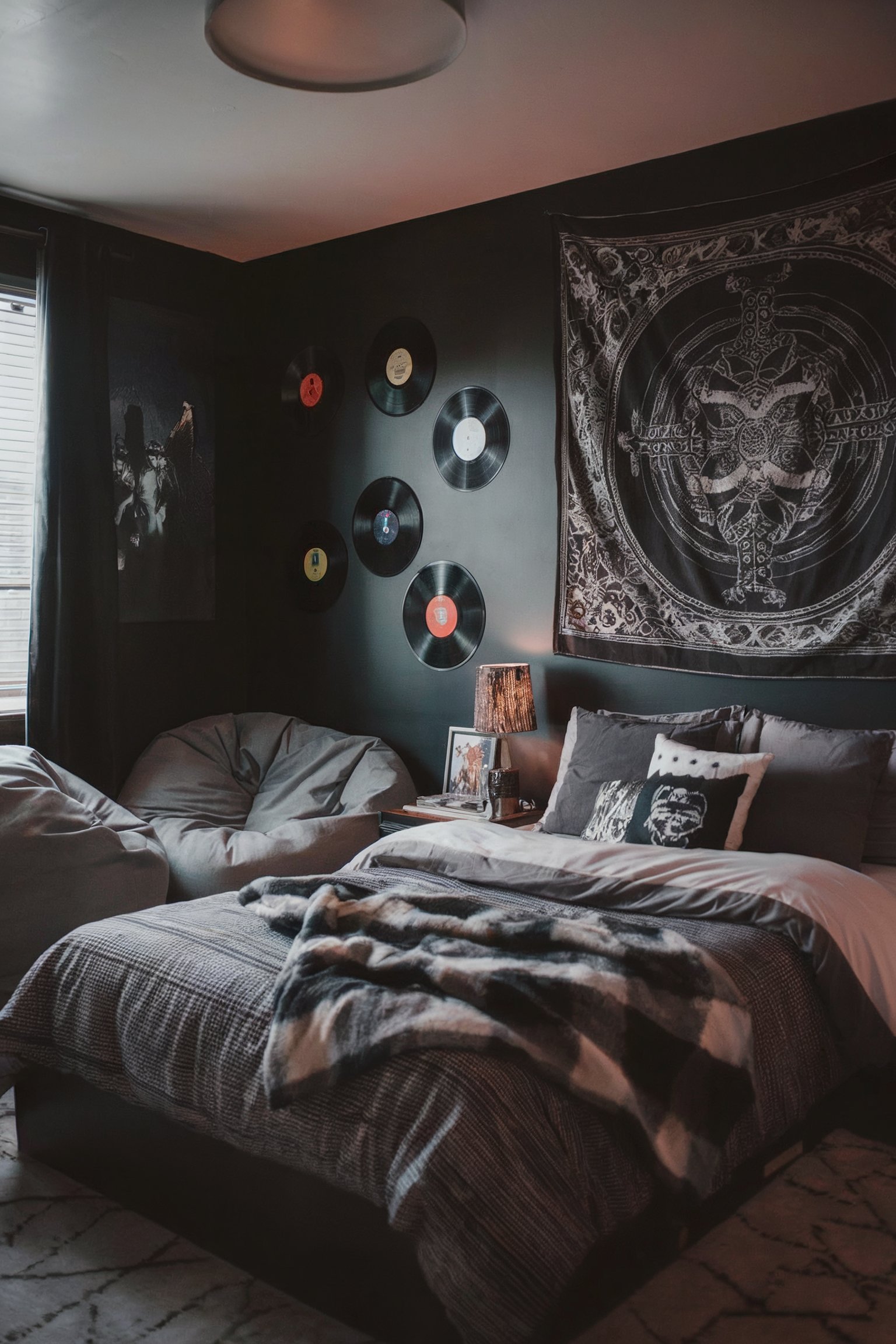 A dark, moody bedroom with vinyl records on the wall and a cozy bed