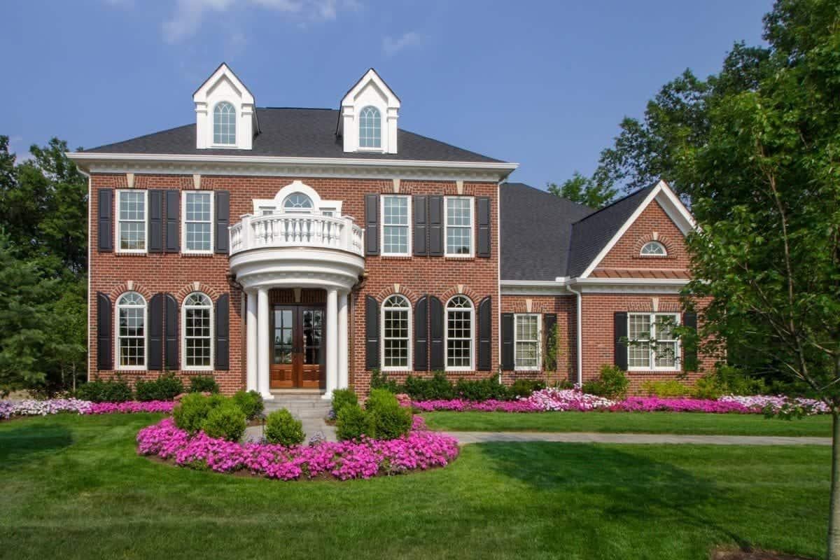 Classic Brick Facade with Elegant Columns and Dormer Windows