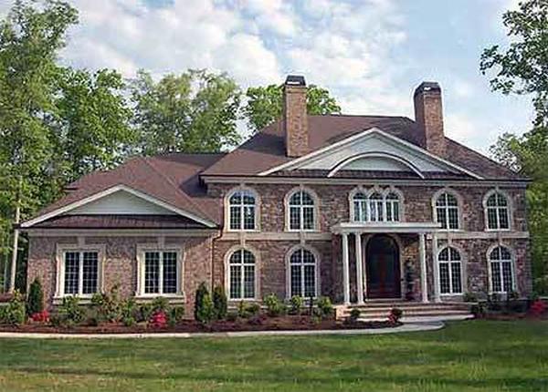 Classic Elegance with Grand Arched Windows and Twin Chimneys