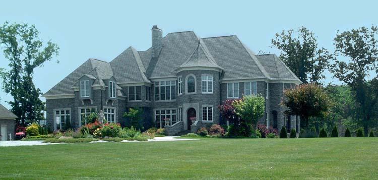 Imposing Stone Manor with Turret and Expansive Lawn