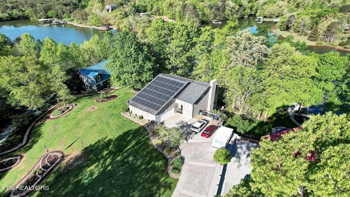 Lakefront Home Featuring Solar Panels and Lush Landscaping