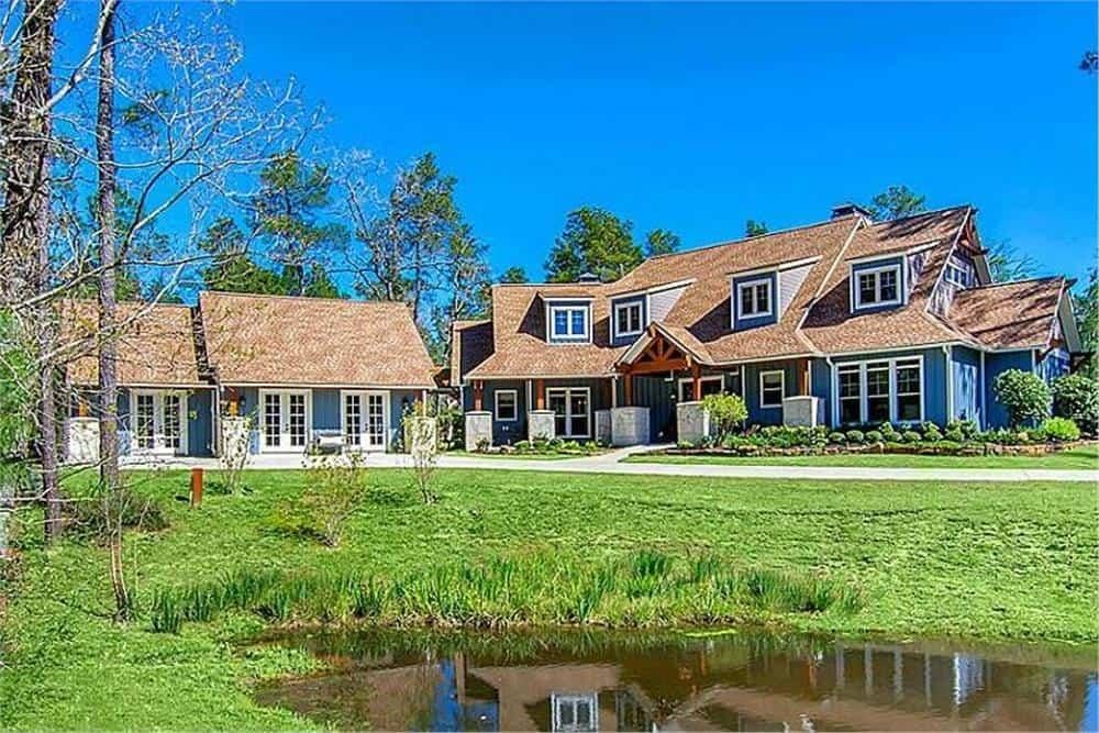 Charming Country Home with Dual Gable Roofs and a Serene Pond View