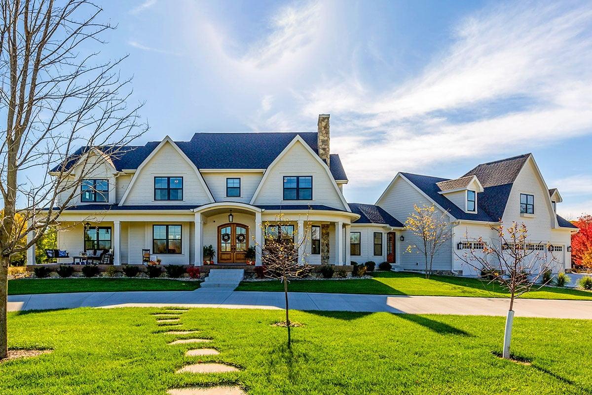 Classic Farmhouse with a Welcoming Porch and Twin Gables