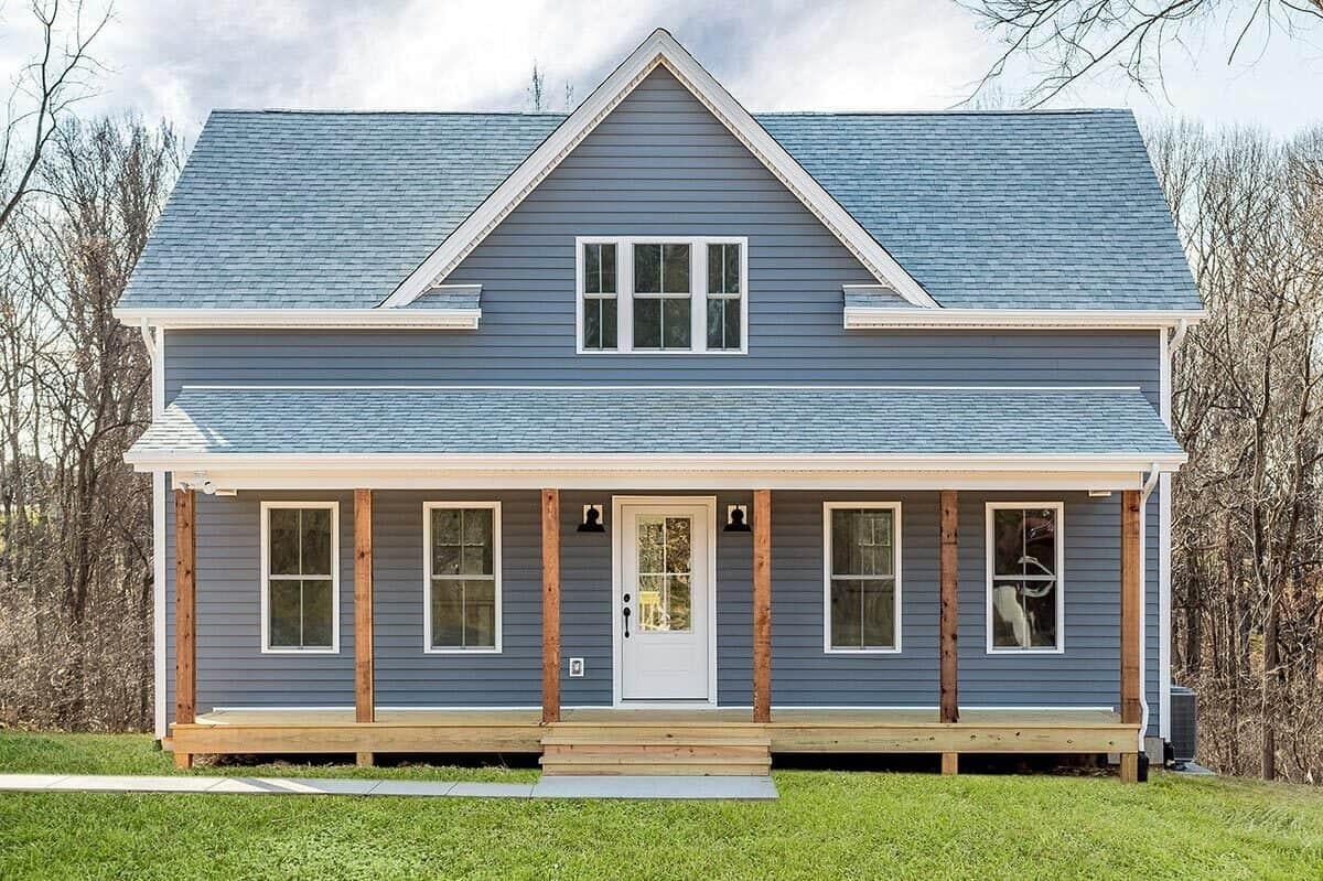 Classic Farmhouse with Striking Blue Siding and Warm Wood Accents