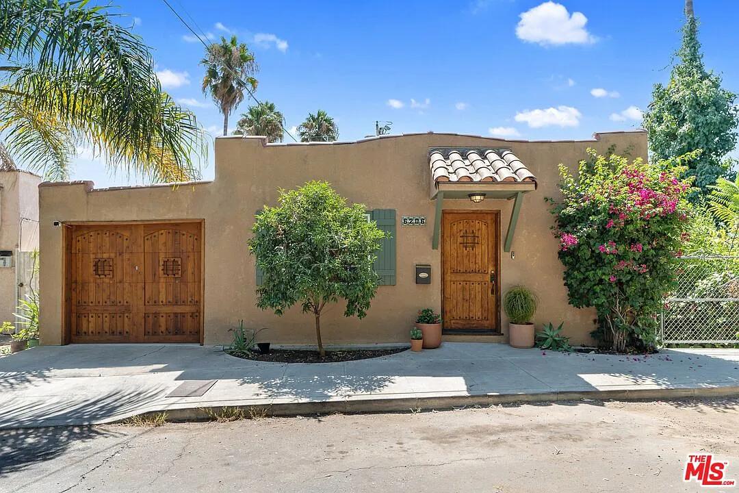 Charming Spanish Revival with Rustic Wooden Accents
