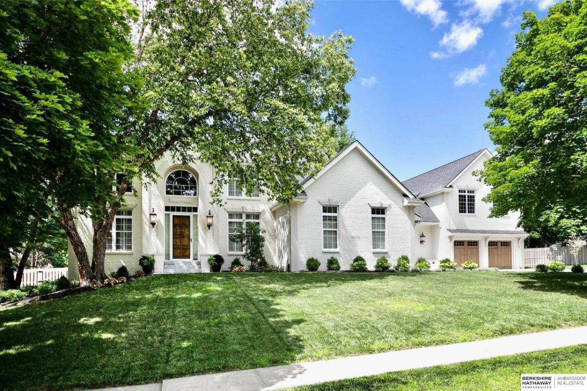 Classic Elegance with Arched Entry and Lush Surroundings