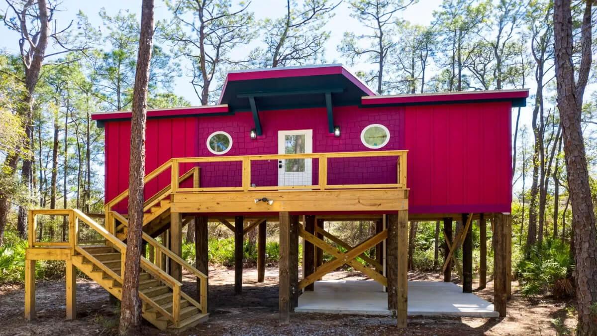 Bright Red Elevated Cabin with Nautical Windows