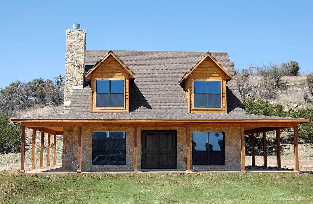 Rustic Charm with a Stone Chimney and Dormer Windows