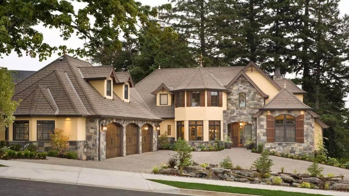 Stone Facade and Arched Garage Doors Create a Timeless Appeal