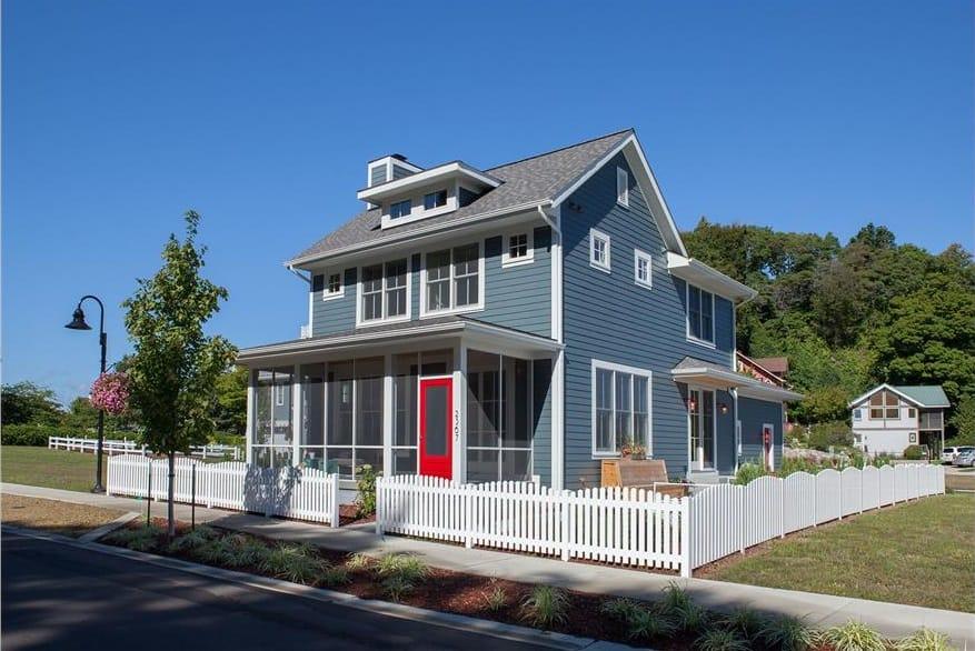 Classic Blue House with a Bold Red Door and White Picket Fence