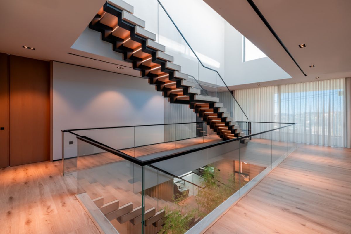 Staircase with glass panels leading to the third floor 