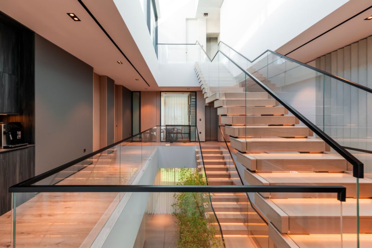 Staircase with glass panels leading to the third floor 