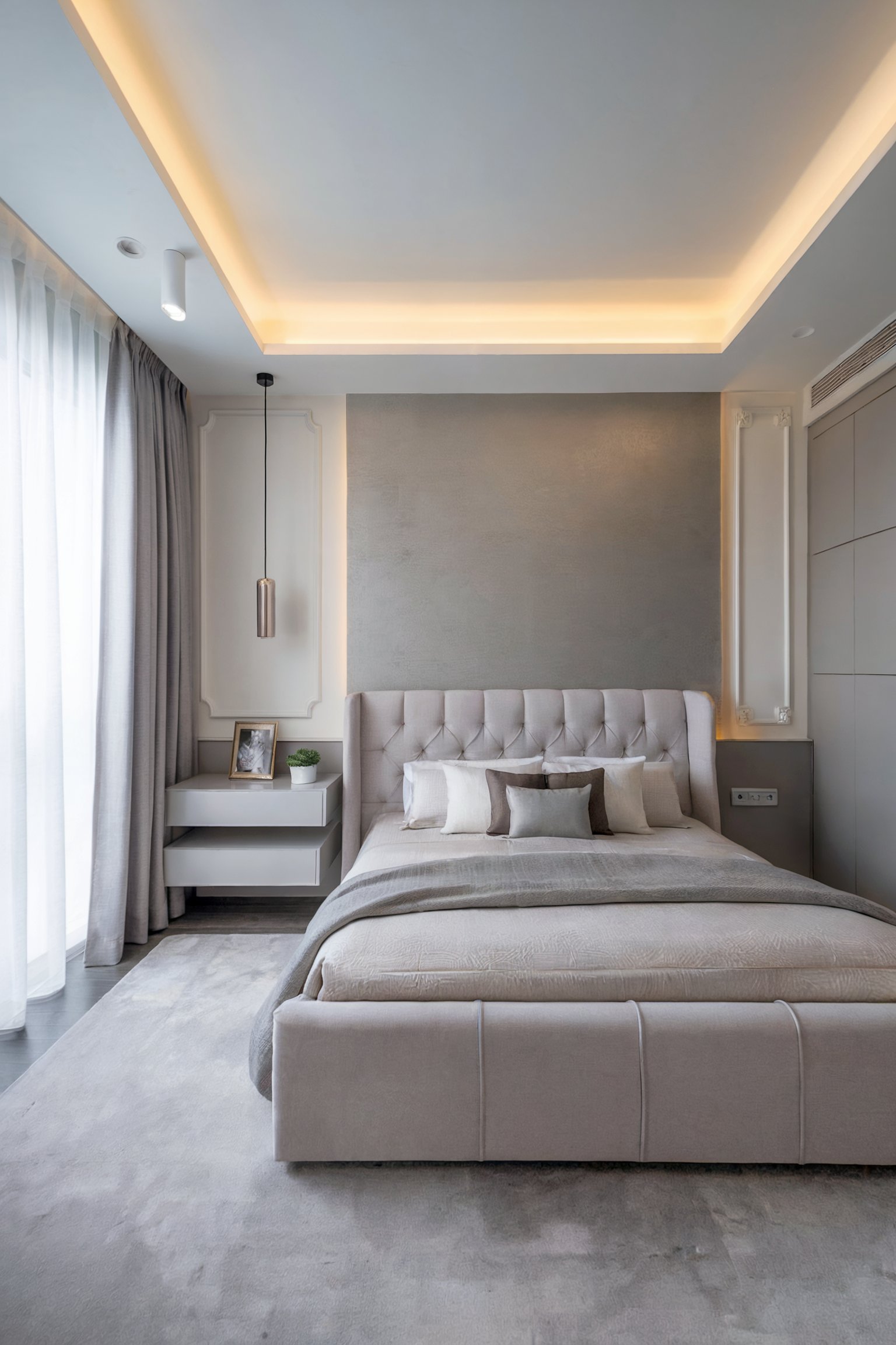 Sleek contemporary bedroom with a soft gray palette, tufted headboard, floating side tables, and warm recessed ceiling lighting