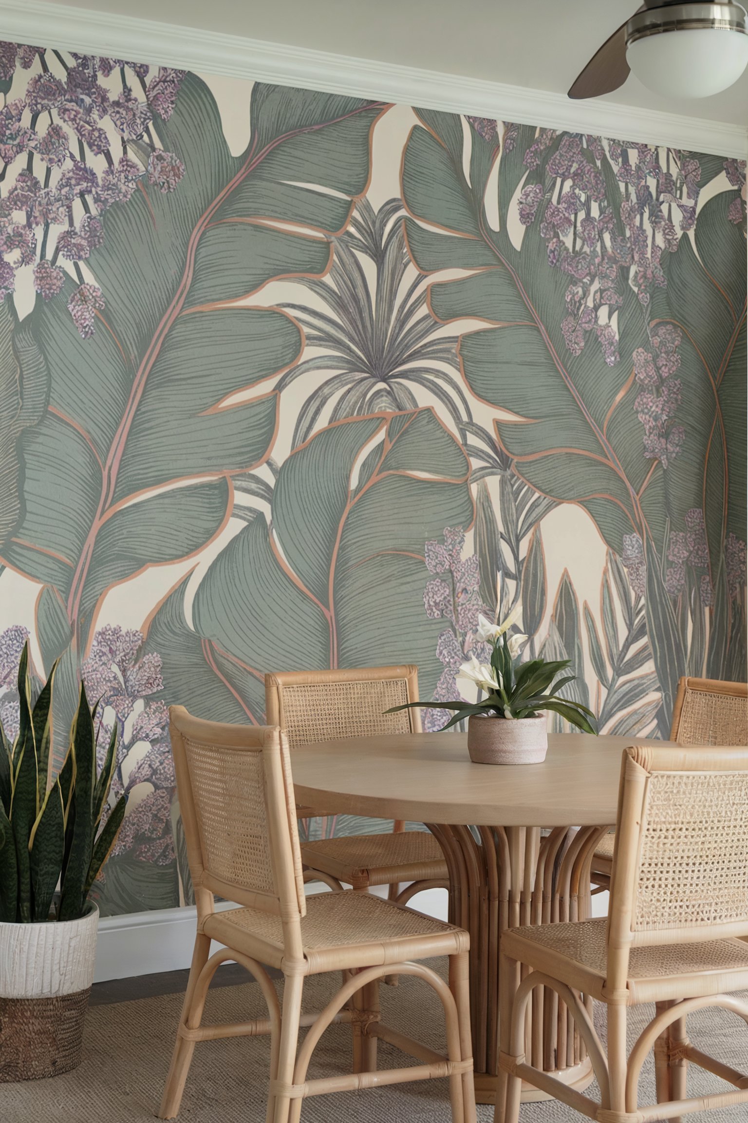 Tropical-inspired dining room with oversized green leaf wallpaper, wicker chairs, and a light wooden table for a natural look