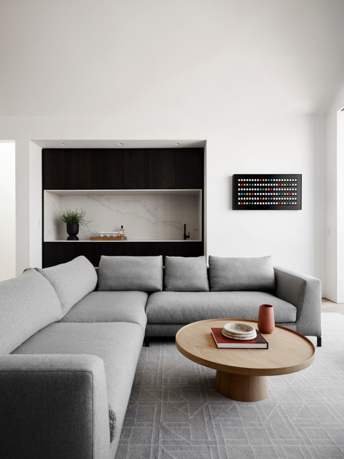 The library bar echoes the aesthetic of the adjacent kitchen.