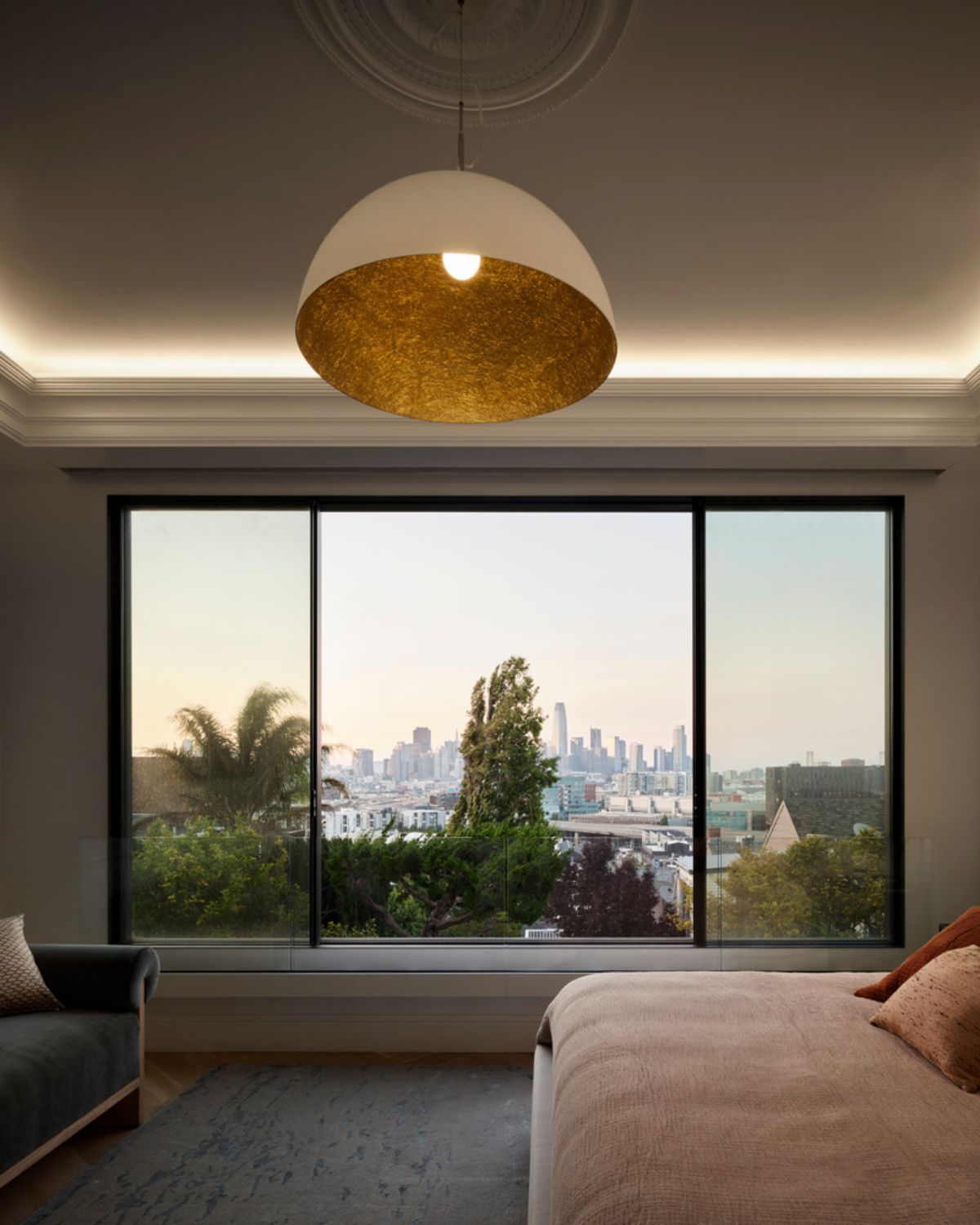 The master bedroom features a Mezza Luna Pendant in white with gold finish by In-Es Art Design from Lumens, and cove lighting.