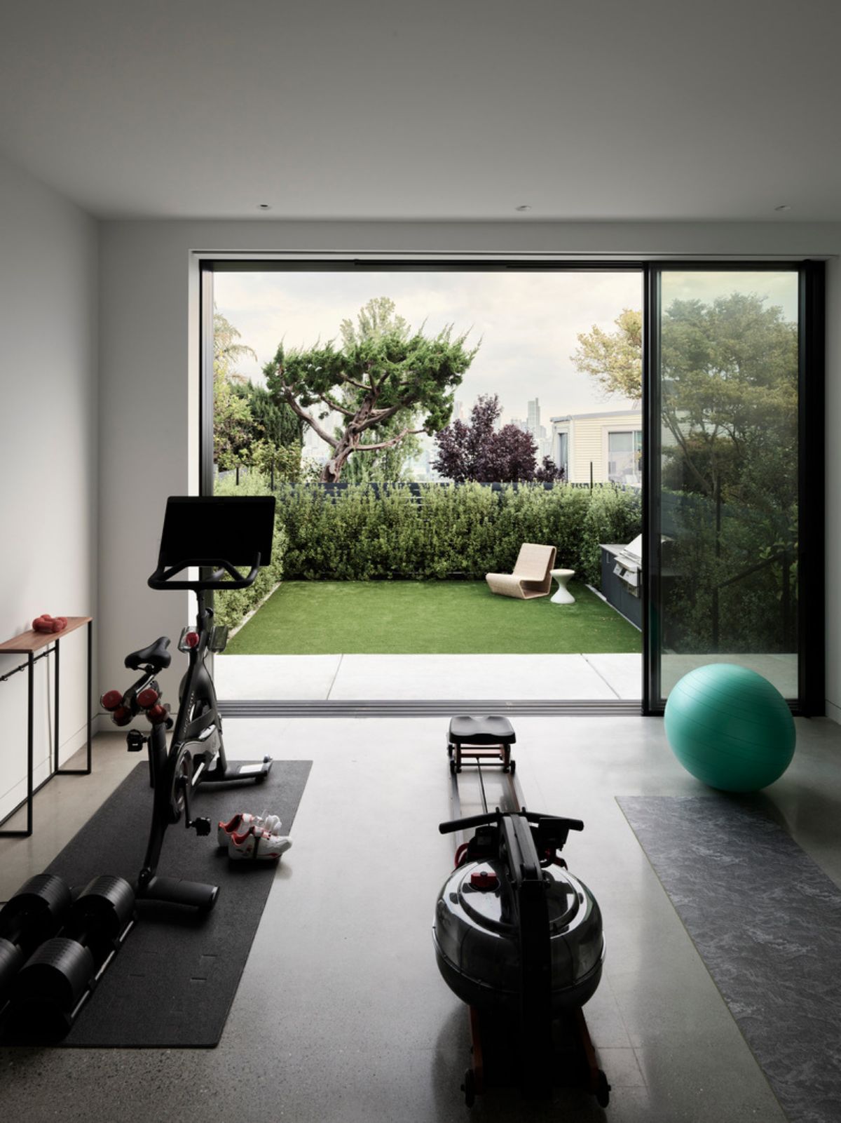 The exercise area which has concrete flooring looks out onto the garden.