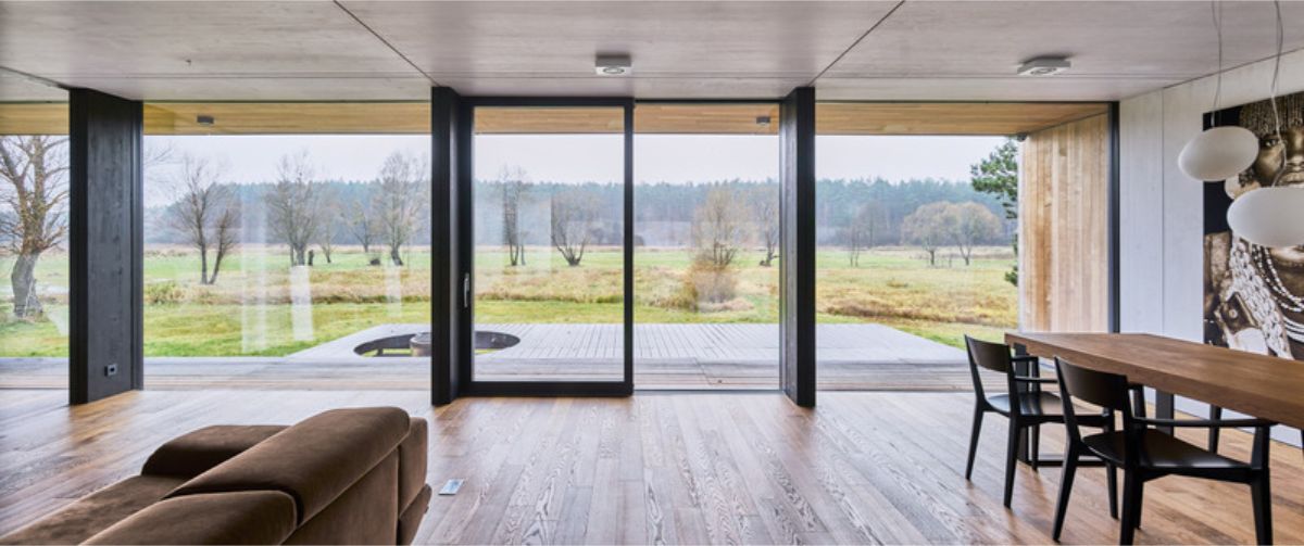 A large set og glass doors that open onto outdoor area