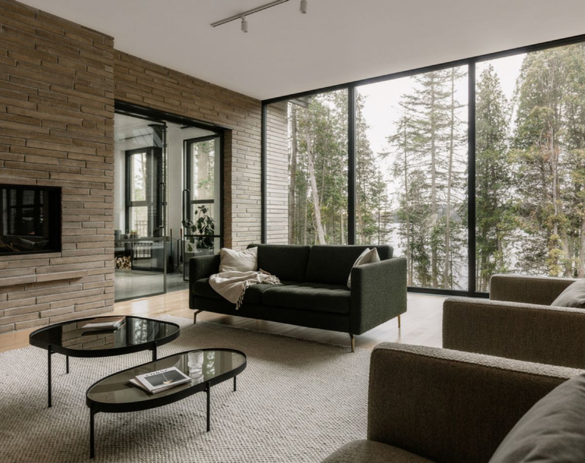 Bright living room with large glass windows, sofa and glass center table