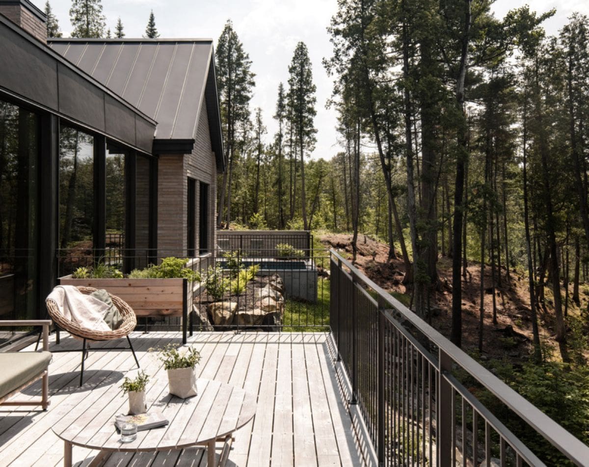 Balcony of the house with a wooden round table and chair