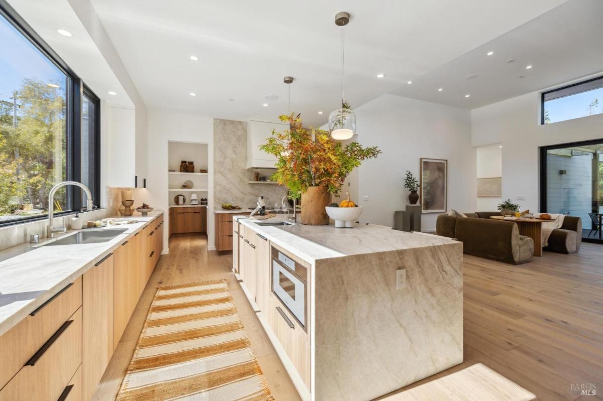Kitchen with marble counters and natural light.