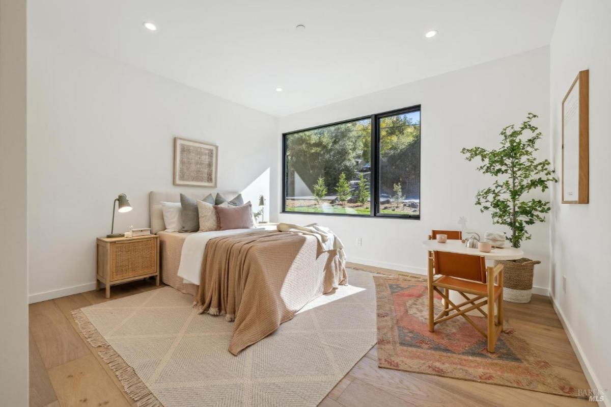 Bedroom with desk and natural lighting.