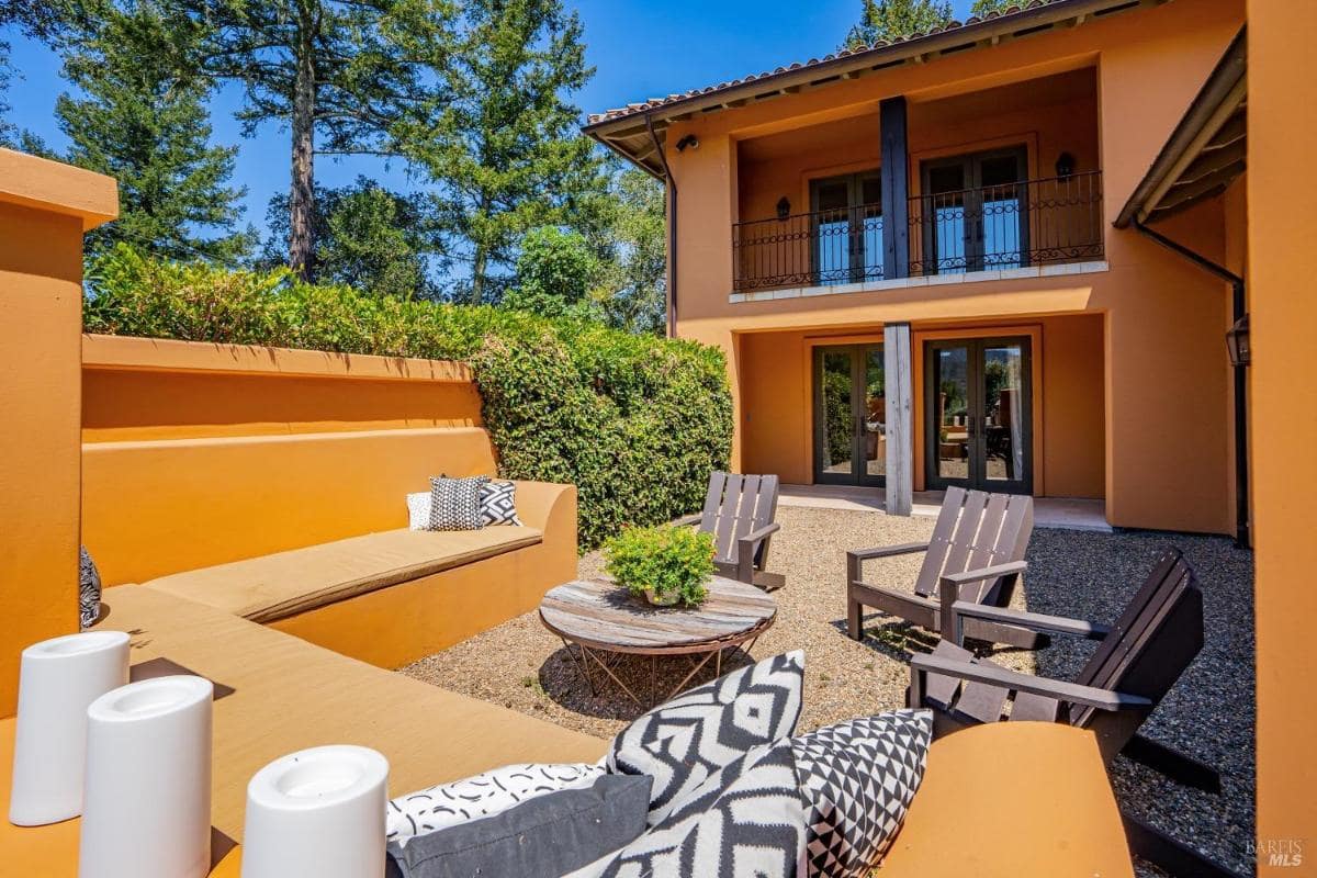 Courtyard with built-in seating, a round table, and direct access to the building.
