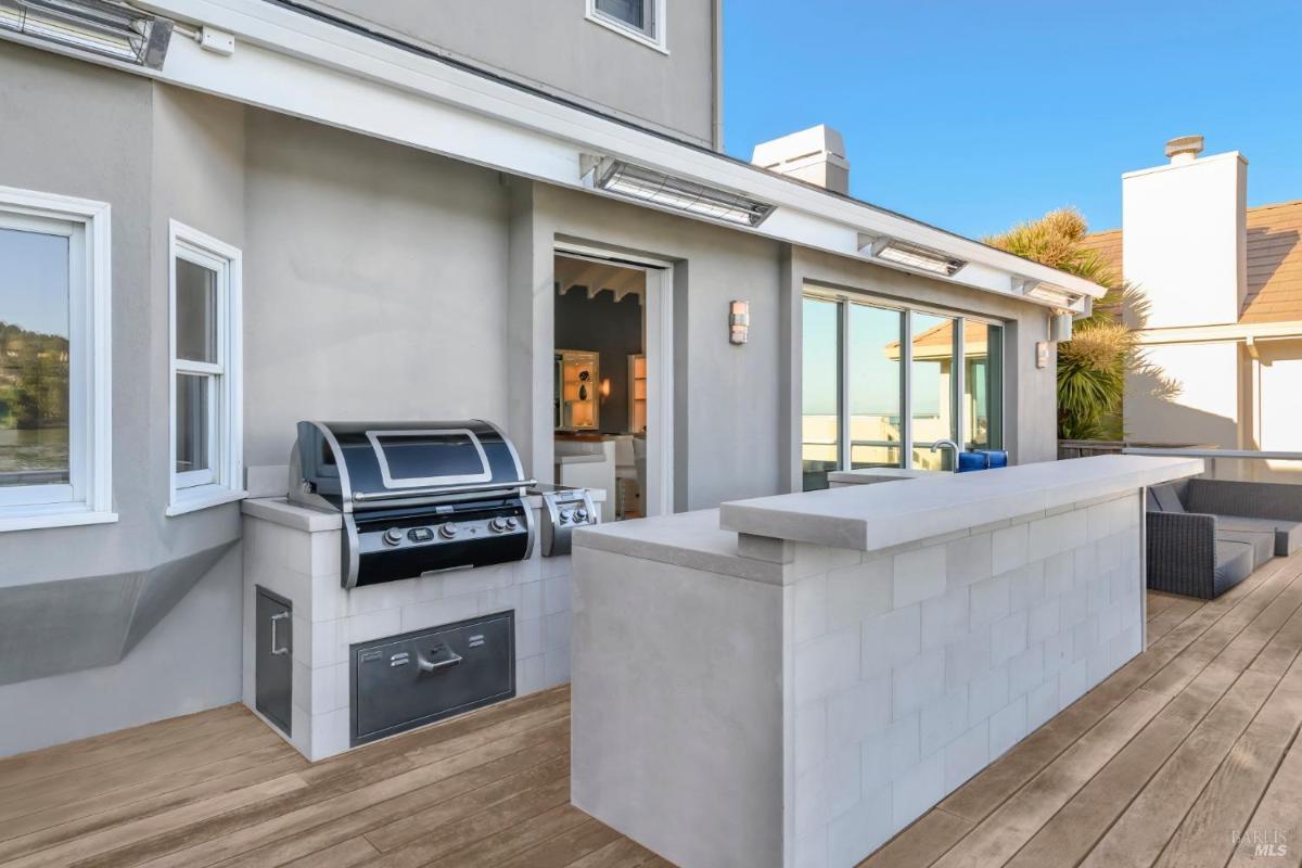 Outdoor deck with a grill and bar area.