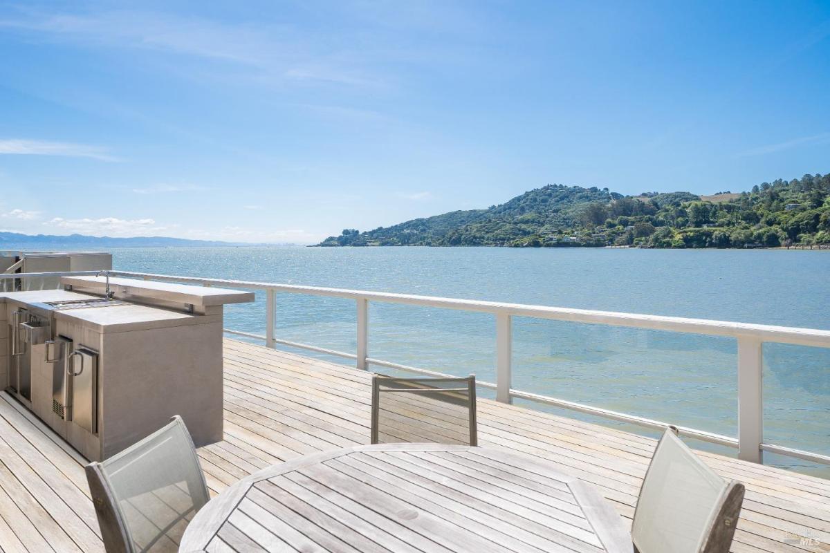 Deck with a dining table and water views.