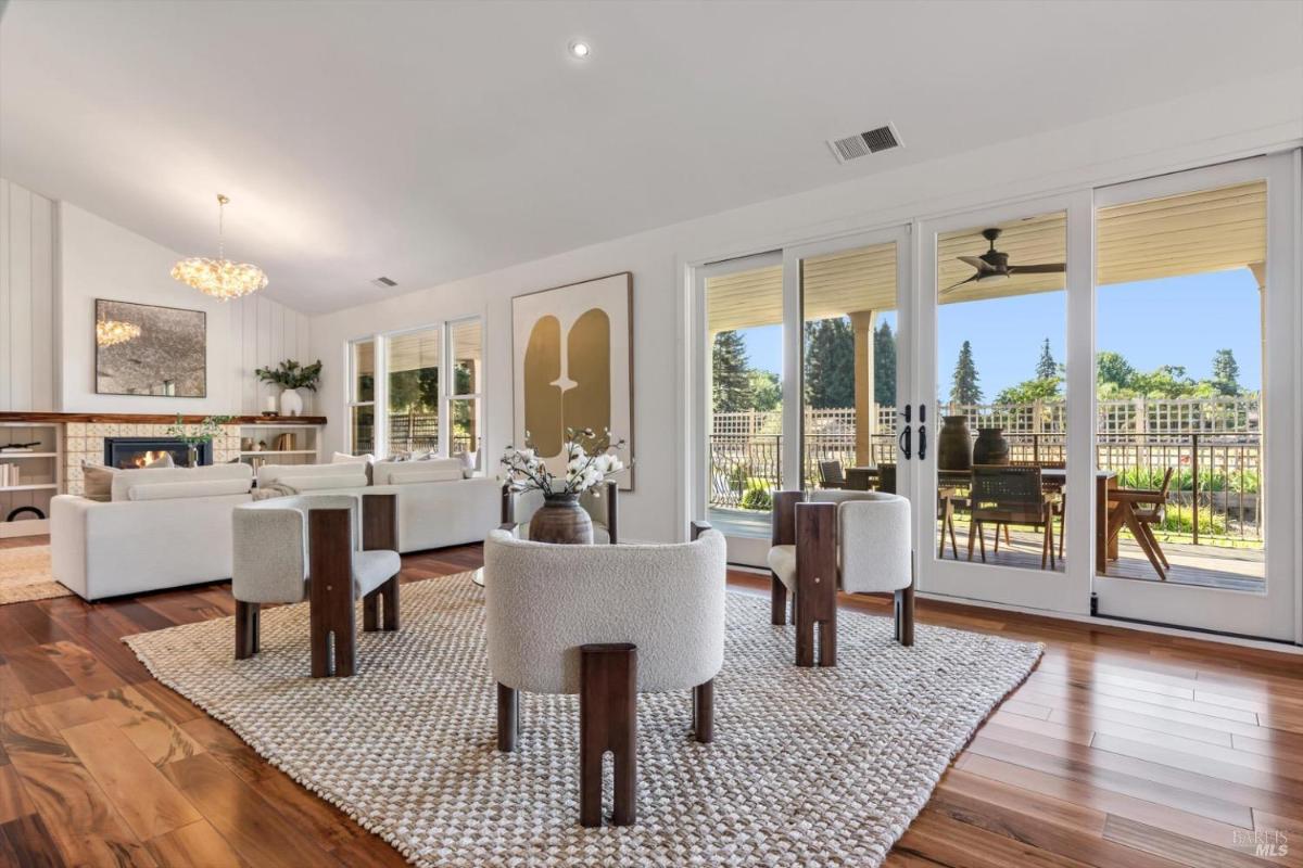 Living room with seating, fireplace, and access to a porch.