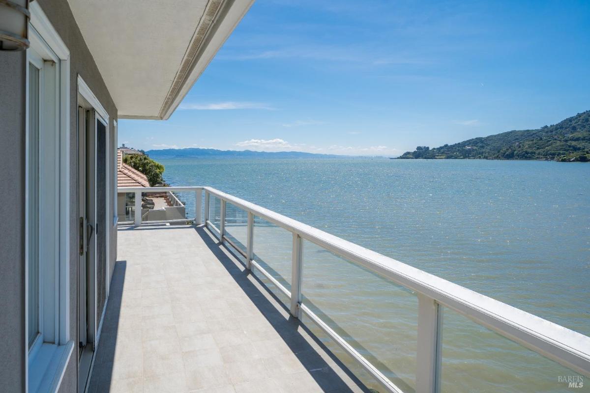 Balcony with railing and views of the water.