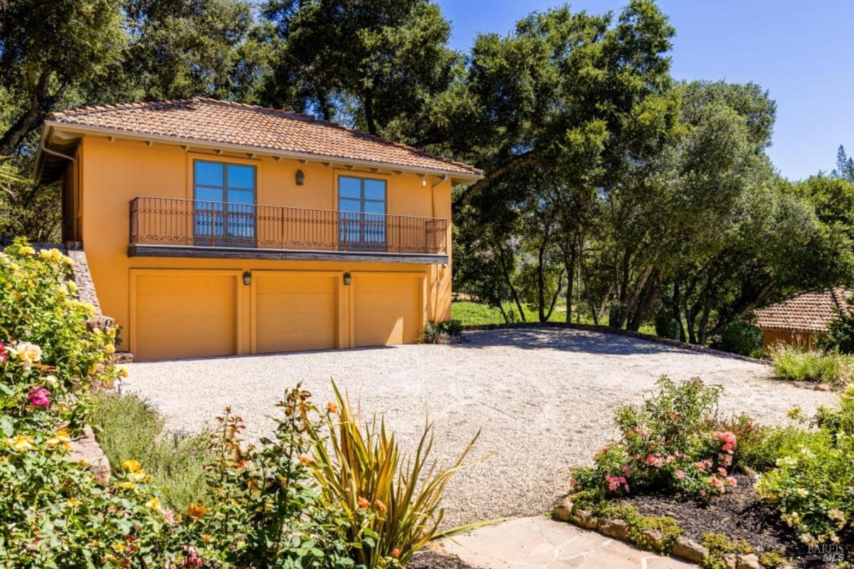 Three-car garage with an upper-level balcony.