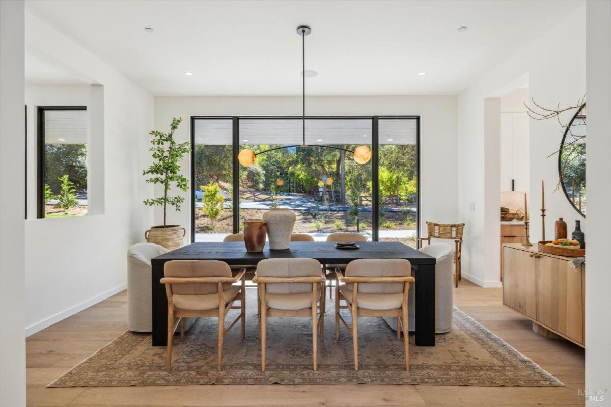 Dining room with a large window overlooking the outdoors.