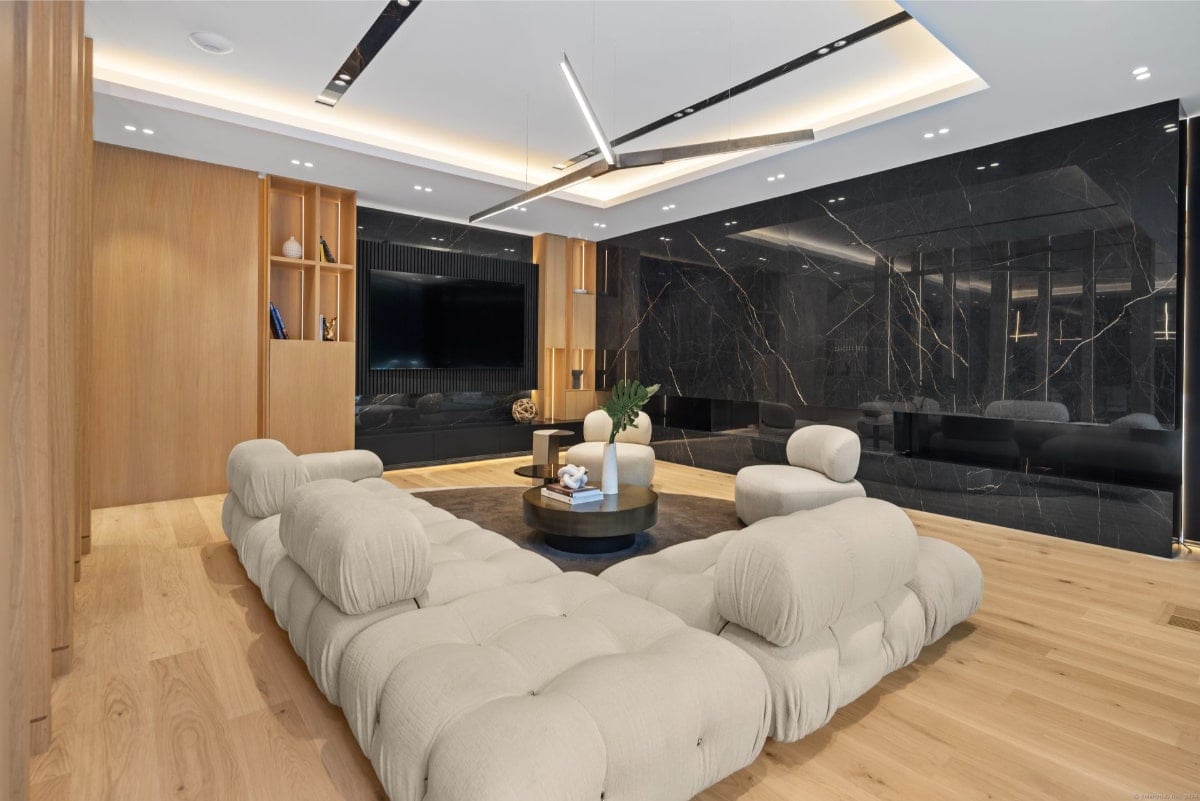 Living room with off-white sectional sofa arranged around a circular coffee table.