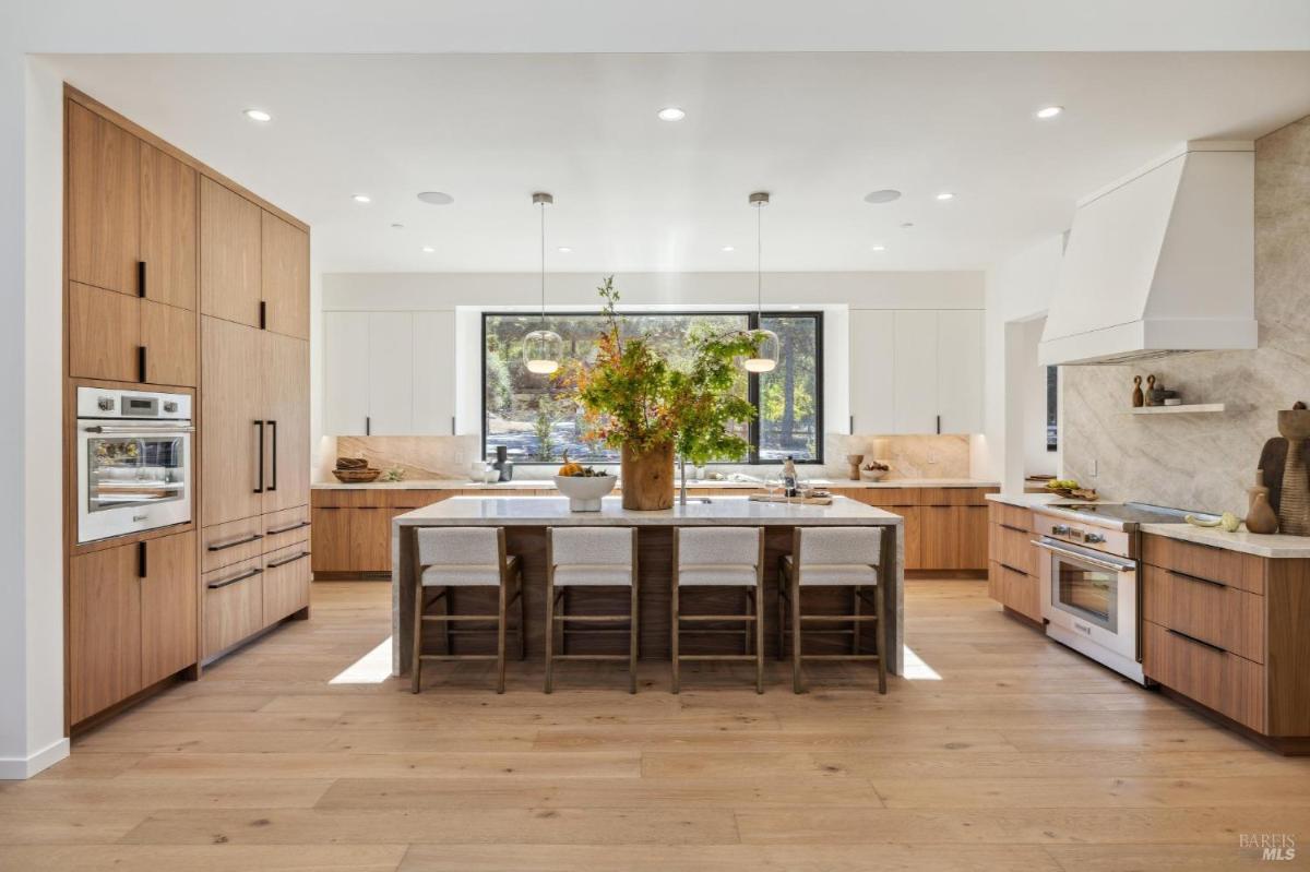 Kitchen with a central island and built-in appliances.