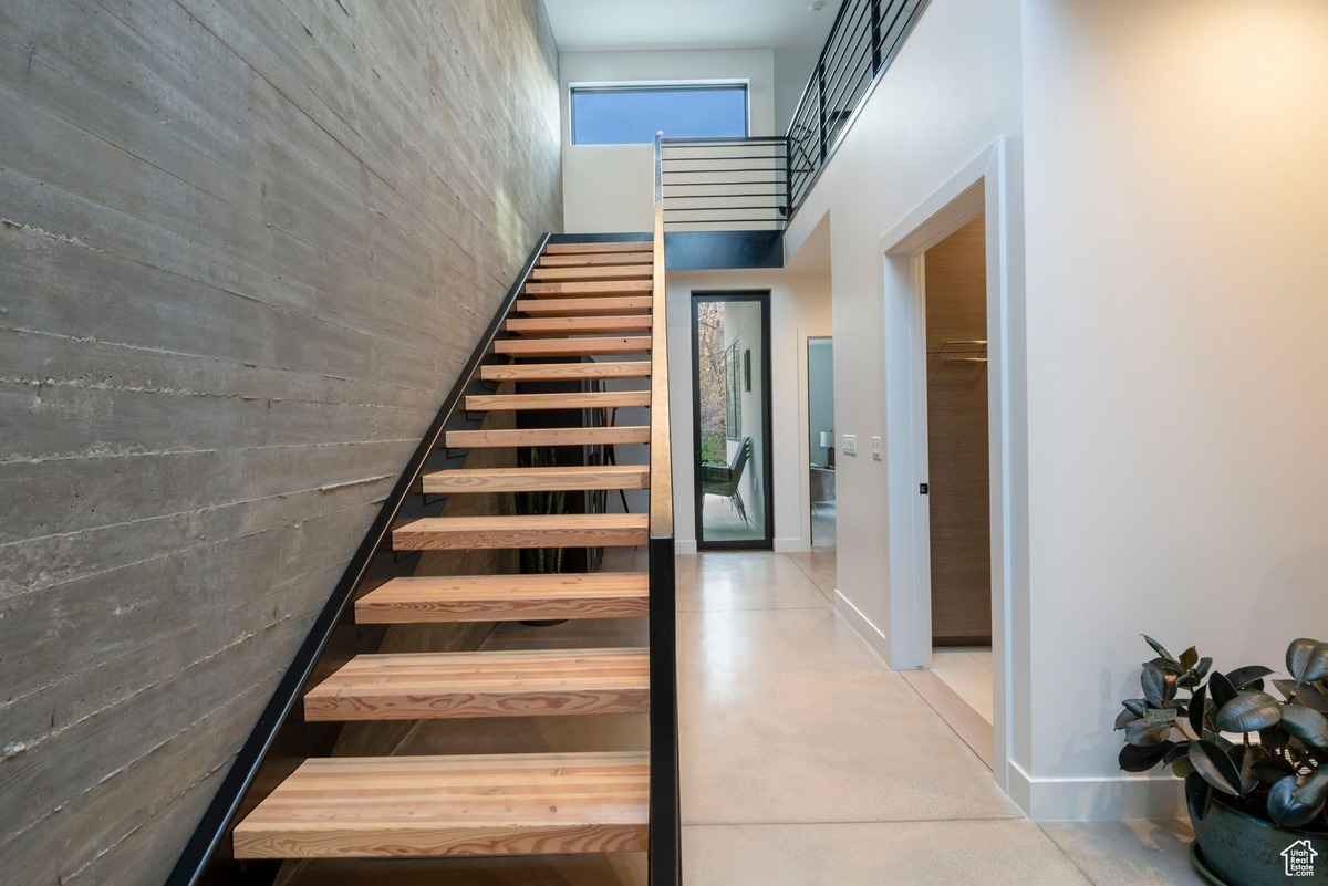 A stylish interior featuring a wooden console table, a large mirror, and cozy seating.